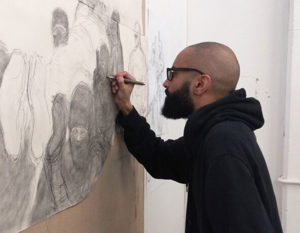 A man drawing on a wall