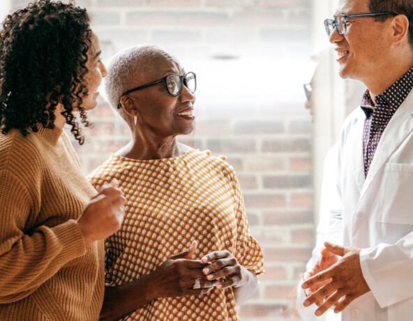 Doctor talking to 2 people.