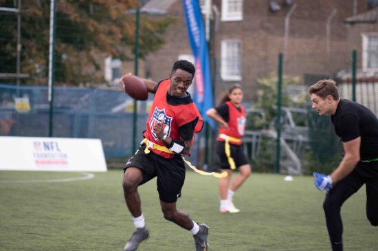 Omari playing flag football