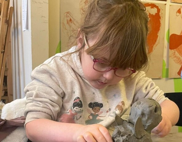 Child moulding clay.