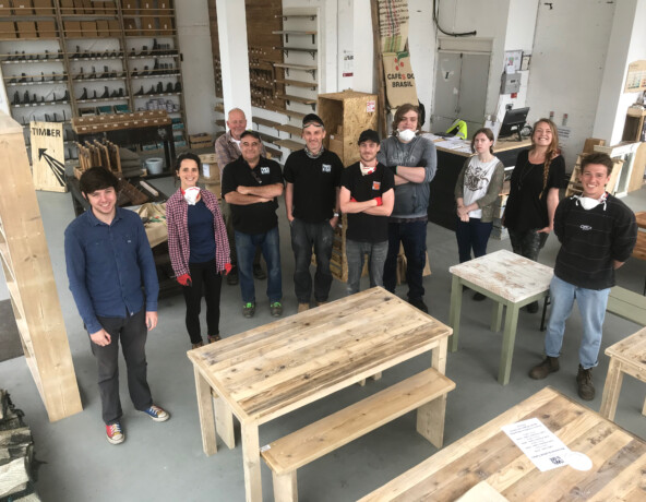 Staff & volunteers standing in wood workshop